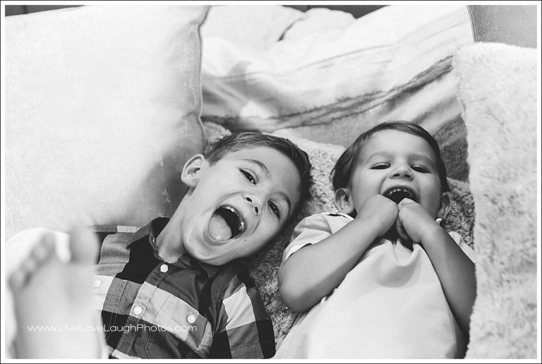 Two brothers laughing during their family photo shoot in Saddle River